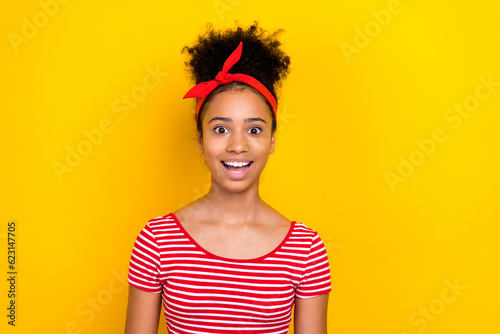 Photo of positive excited lady wear striped red t-shirt open mouth empty space isolated yellow color background