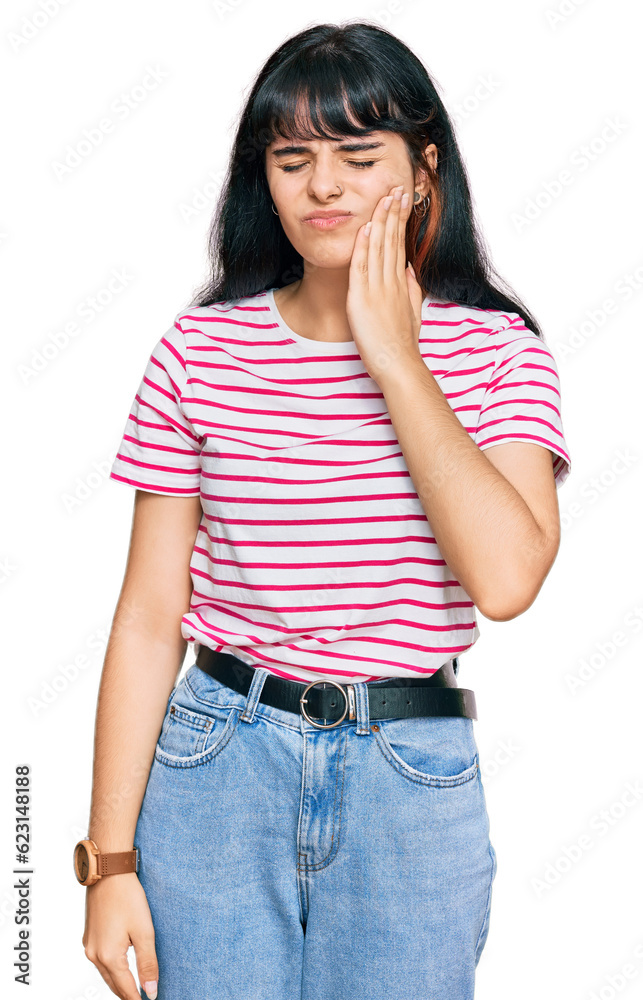 Young hispanic girl wearing casual clothes touching mouth with hand with painful expression because of toothache or dental illness on teeth. dentist Young hispanic girl wearing casual clothes touching mouth with hand with painful expression because of toothache or dental illness on teeth. dentist