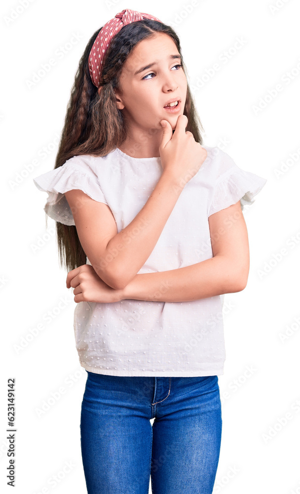 Cute hispanic child girl wearing casual white tshirt thinking worried about a question, concerned and nervous with hand on chin Cute hispanic child girl wearing casual white tshirt thinking worried about a question, concerned and nervous with hand on chin