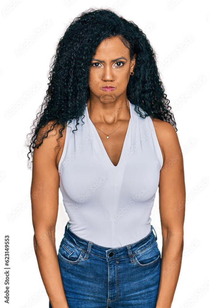 Middle age african american woman wearing casual style with sleeveless shirt puffing cheeks with funny face. mouth inflated with air, crazy expression. Middle age african american woman wearing casual style with sleeveless shirt puffing cheeks with funny face. mouth inflated with air, crazy expression.