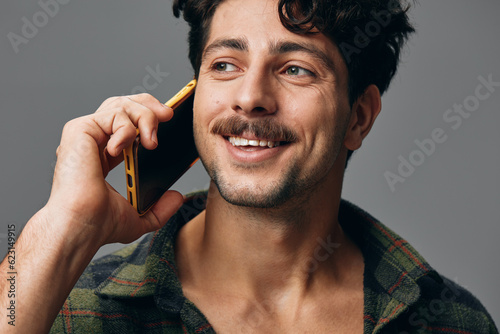 Person man happy stylish studio background isolated technology phone grey lifestyle head serious smile
