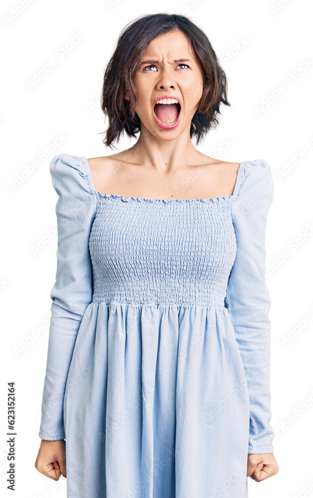 Young beautiful girl wearing casual clothes angry and mad screaming frustrated and furious, shouting with anger. rage and aggressive concept. Young beautiful girl wearing casual clothes angry and mad screaming frustrated and furious, shouting with anger. rage and aggressive concept.