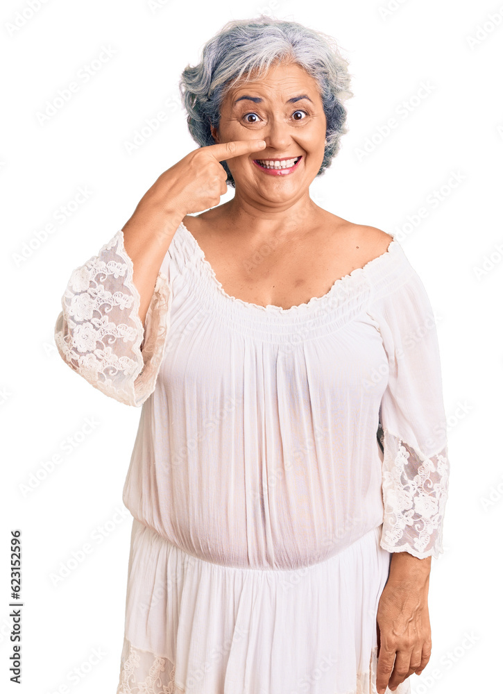 Senior woman with gray hair wearing bohemian style pointing with hand finger to face and nose, smiling cheerful. beauty concept Senior woman with gray hair wearing bohemian style pointing with hand finger to face and nose, smiling cheerful. beauty concept