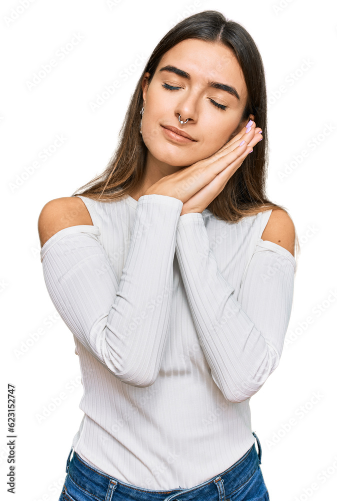 Young hispanic woman wearing casual clothes sleeping tired dreaming and posing with hands together while smiling with closed eyes. Young hispanic woman wearing casual clothes sleeping tired dreaming and posing with hands together while smiling with closed eyes.