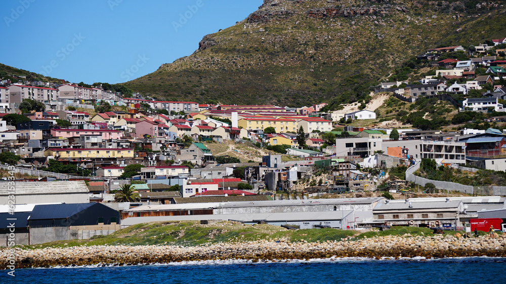 Local South African township housing residence area around Hout Bay hill side landscape from ocean