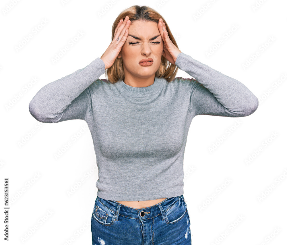 Young caucasian woman wearing casual clothes suffering from headache desperate and stressed because pain and migraine. hands on head. Young caucasian woman wearing casual clothes suffering from headache desperate and stressed because pain and migraine. hands on head.