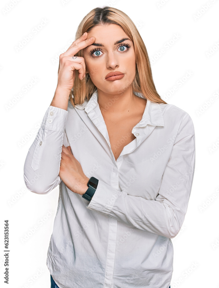 Young caucasian woman wearing casual clothes worried and stressed about a problem with hand on forehead, nervous and anxious for crisis Young caucasian woman wearing casual clothes worried and stressed about a problem with hand on forehead, nervous and anxious for crisis