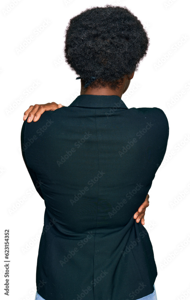 Young african american girl wearing casual clothes, hugging herself. Young african american girl wearing casual clothes, hugging herself.
