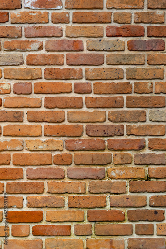 Old brick wall made up of home-made bricks