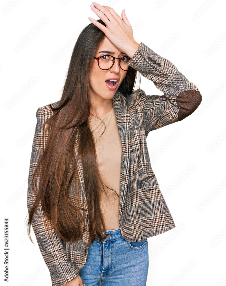 Young hispanic girl wearing business clothes and glasses surprised with hand on head for mistake, remember error. forgot, bad memory concept.