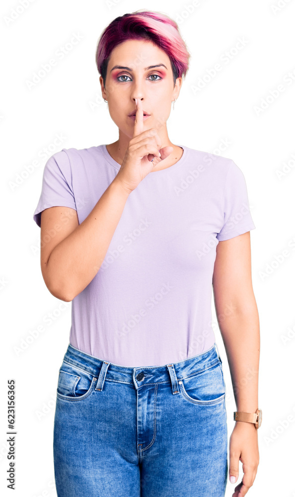 Young beautiful woman with pink hair wearing casual clothes asking to be quiet with finger on lips. silence and secret concept. Young beautiful woman with pink hair wearing casual clothes asking to be quiet with finger on lips. silence and secret concept.
