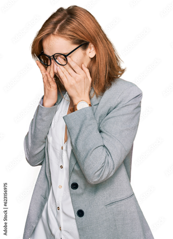 Young caucasian woman wearing business style and glasses rubbing eyes for fatigue and headache, sleepy and tired expression. vision problem Young caucasian woman wearing business style and glasses rubbing eyes for fatigue and headache, sleepy and tired expression. vision problem