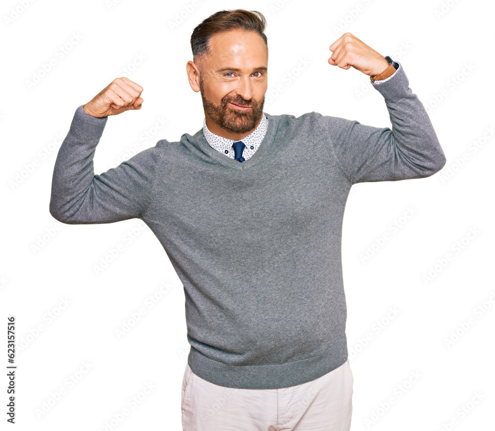 Handsome middle age man wearing business clothes showing arms muscles smiling proud. fitness concept. Handsome middle age man wearing business clothes showing arms muscles smiling proud. fitness concept.