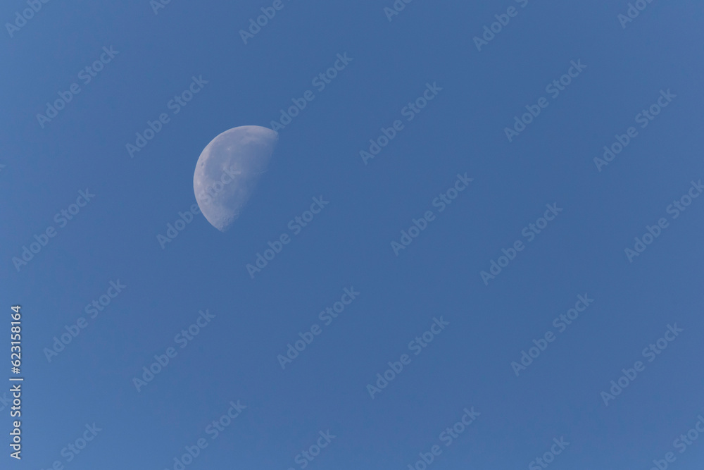 waning gibbous Moon in clear sky at day