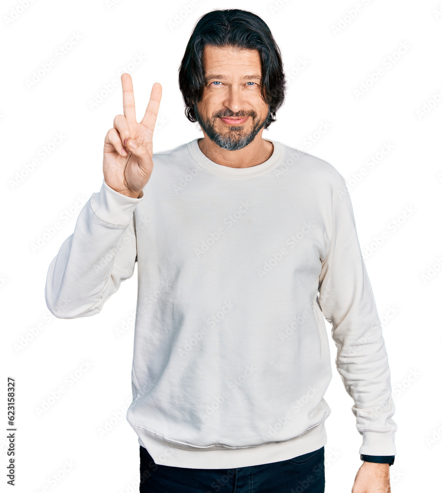 Middle age caucasian man wearing casual clothes smiling looking to the camera showing fingers doing victory sign. number two. Middle age caucasian man wearing casual clothes smiling looking to the camera showing fingers doing victory sign. number two.