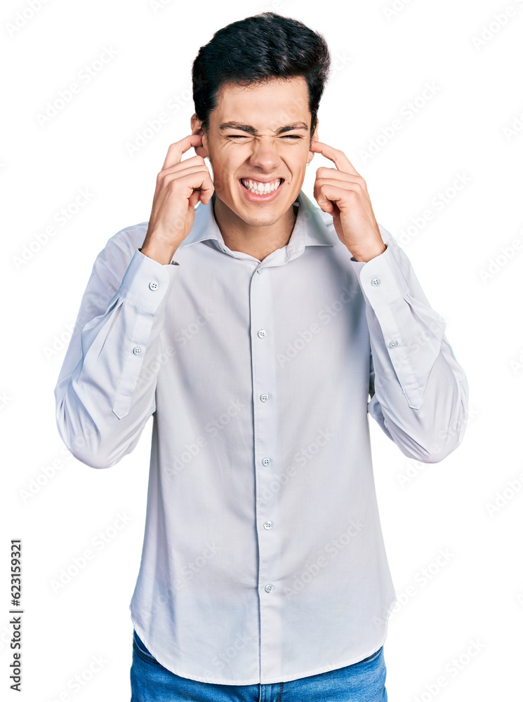 Young hispanic business man wearing business clothes covering ears with fingers with annoyed expression for the noise of loud music. deaf concept. Young hispanic business man wearing business clothes covering ears with fingers with annoyed expression for the noise of loud music. deaf concept.