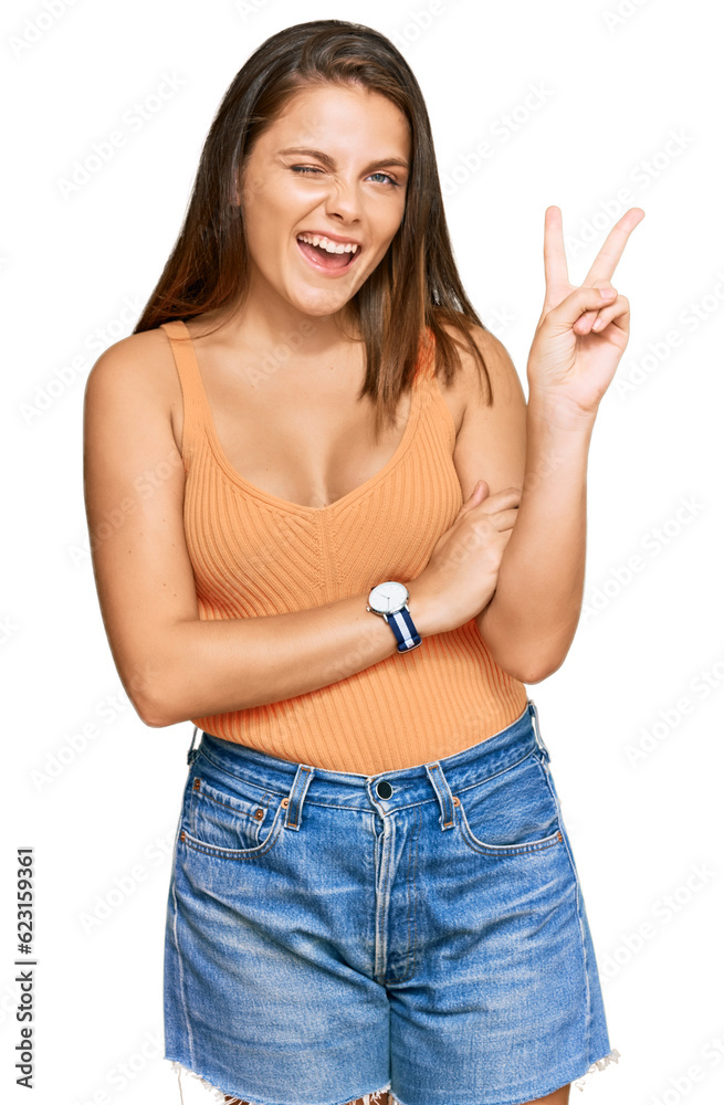 Young caucasian woman wearing casual clothes smiling with happy face winking at the camera doing victory sign. number two. Young caucasian woman wearing casual clothes smiling with happy face winking at the camera doing victory sign. number two.