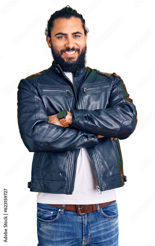 Young arab man wearing casual leather jacket happy face smiling with crossed arms looking at the camera. positive person. Young arab man wearing casual leather jacket happy face smiling with crossed arms looking at the camera. positive person.