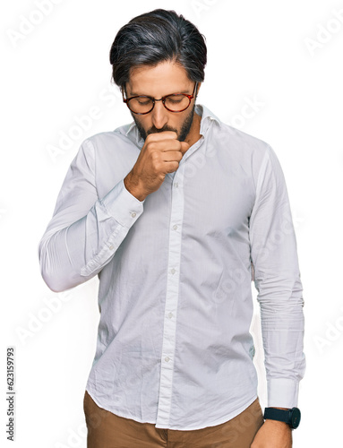 Young hispanic man wearing business shirt and glasses feeling unwell and coughing as symptom for cold or bronchitis. health care concept.