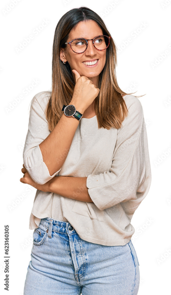 Young woman wearing casual clothes and glasses with hand on chin thinking about question, pensive expression. smiling with thoughtful face. doubt concept. Young woman wearing casual clothes and glasses with hand on chin thinking about question, pensive expression. smiling with thoughtful face. doubt concept.