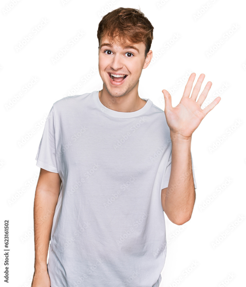 Young caucasian man wearing casual white t shirt showing and pointing up with fingers number five while smiling confident and happy. Young caucasian man wearing casual white t shirt showing and pointing up with fingers number five while smiling confident and happy.