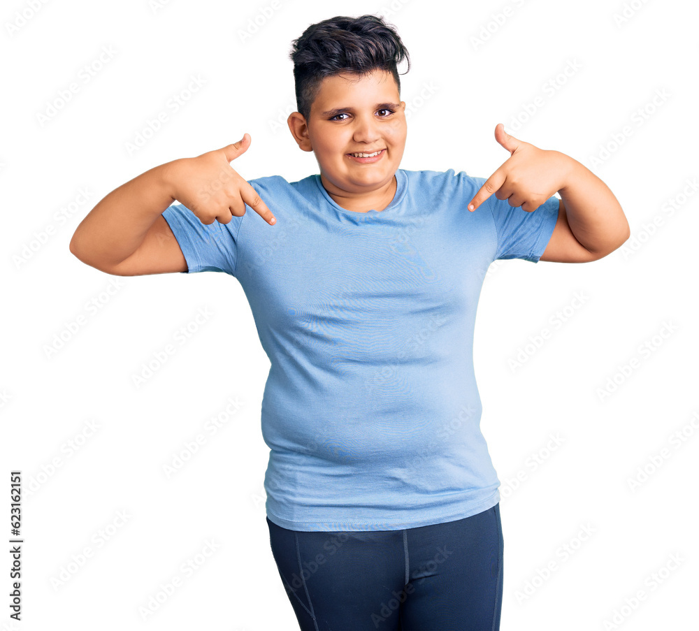 Little boy kid wearing sports workout clothes looking confident with smile on face, pointing oneself with fingers proud and happy. Little boy kid wearing sports workout clothes looking confident with smile on face, pointing oneself with fingers proud and happy.