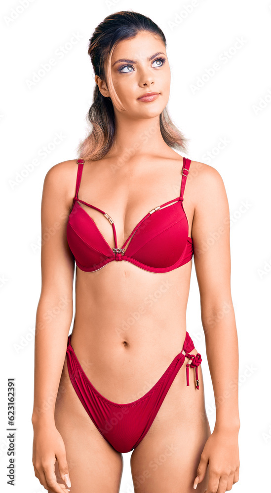 Young beautiful woman wearing bikini smiling looking to the side and staring away thinking. Young beautiful woman wearing bikini smiling looking to the side and staring away thinking.