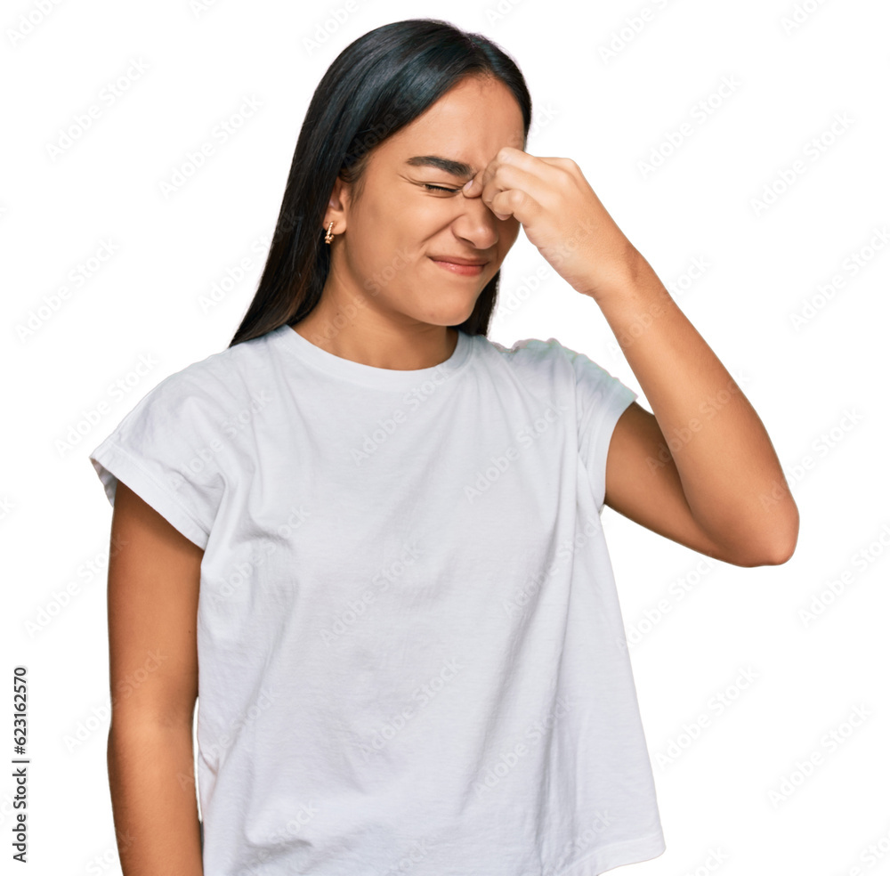 Young asian woman wearing casual white t shirt tired rubbing nose and eyes feeling fatigue and headache. stress and frustration concept. Young asian woman wearing casual white t shirt tired rubbing nose and eyes feeling fatigue and headache. stress and frustration concept.