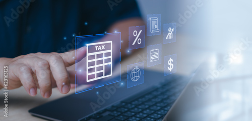 Wallpaper Mural Man hand touching calculator icon with text tax on laptop computer screen showing income or expenses to fill out personal income tax payment form, financial concept or income to calculate tax online Torontodigital.ca