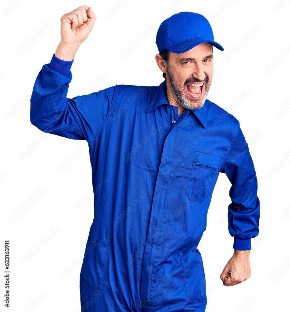 Middle age handsome man wearing mechanic uniform dancing happy and cheerful, smiling moving casual and confident listening to music