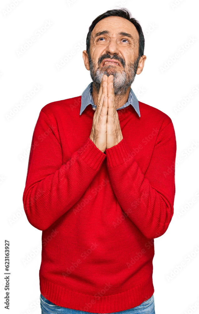 Middle age hispanic man wearing casual clothes begging and praying with hands together with hope expression on face very emotional and worried. begging.