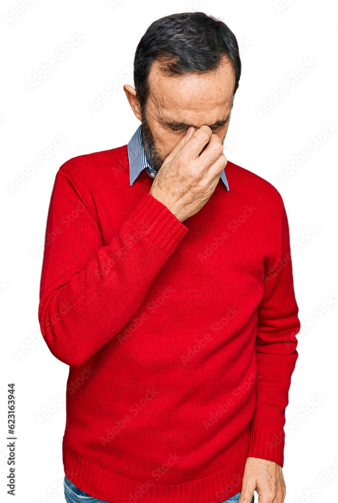 Middle age hispanic man wearing casual clothes tired rubbing nose and eyes feeling fatigue and headache. stress and frustration concept. Middle age hispanic man wearing casual clothes tired rubbing nose and eyes feeling fatigue and headache. stress and frustration concept.