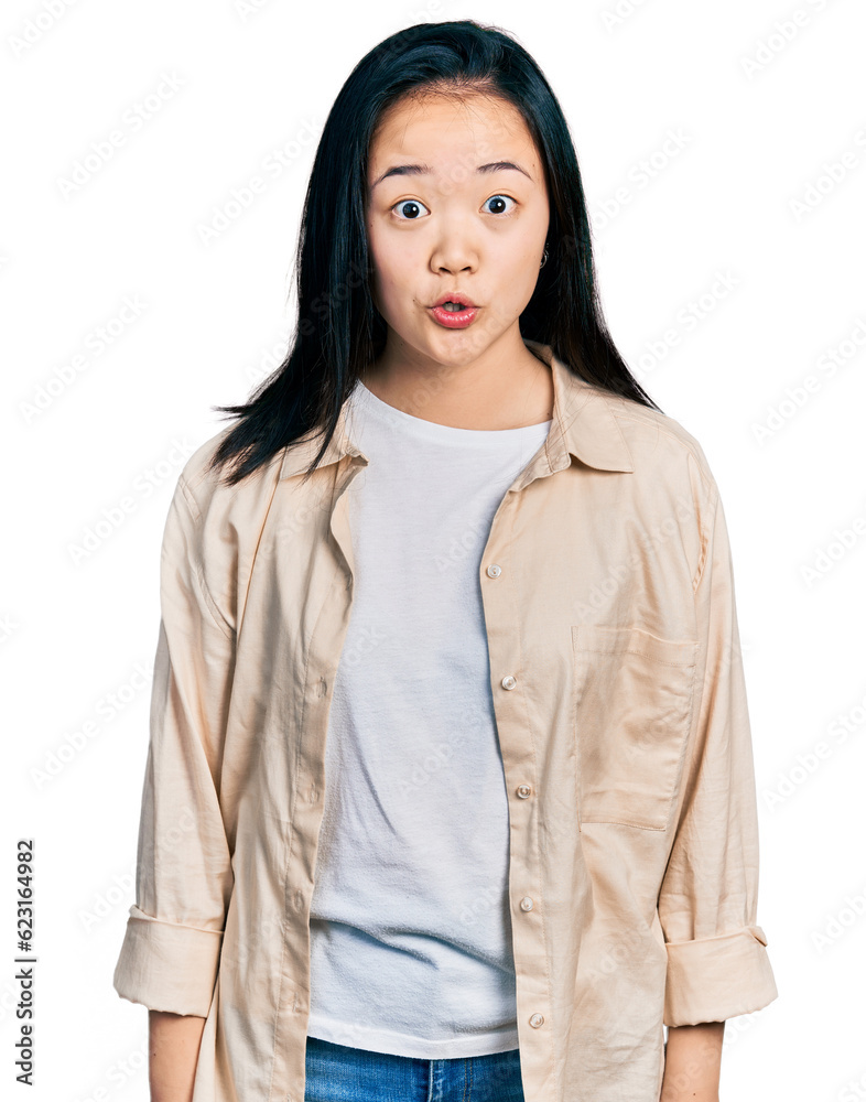Young chinese woman wearing casual white t shirt and jacket afraid and shocked with surprise expression, fear and excited face. Young chinese woman wearing casual white t shirt and jacket afraid and shocked with surprise expression, fear and excited face.
