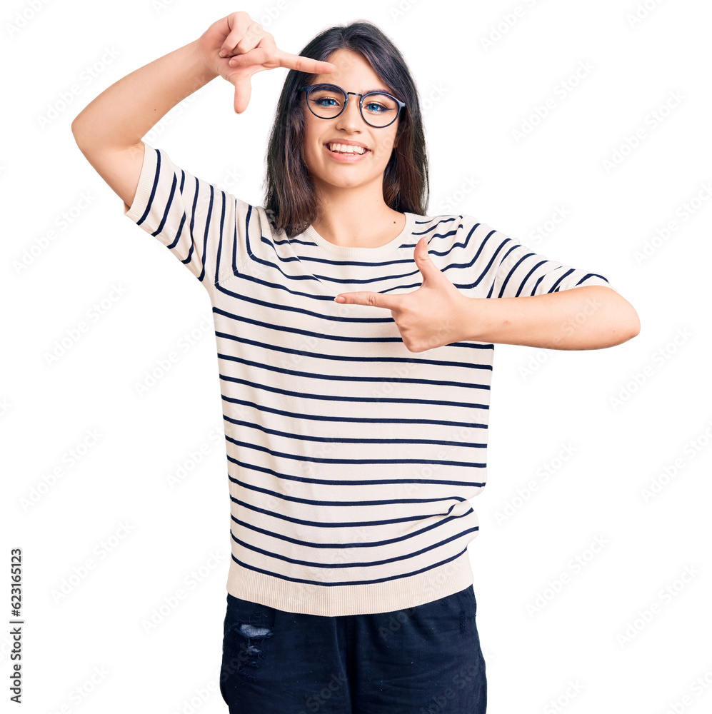 Brunette teenager girl wearing casual clothes and glasses smiling making frame with hands and fingers with happy face. creativity and photography concept. Brunette teenager girl wearing casual clothes and glasses smiling making frame with hands and fingers with happy face. creativity and photography concept.