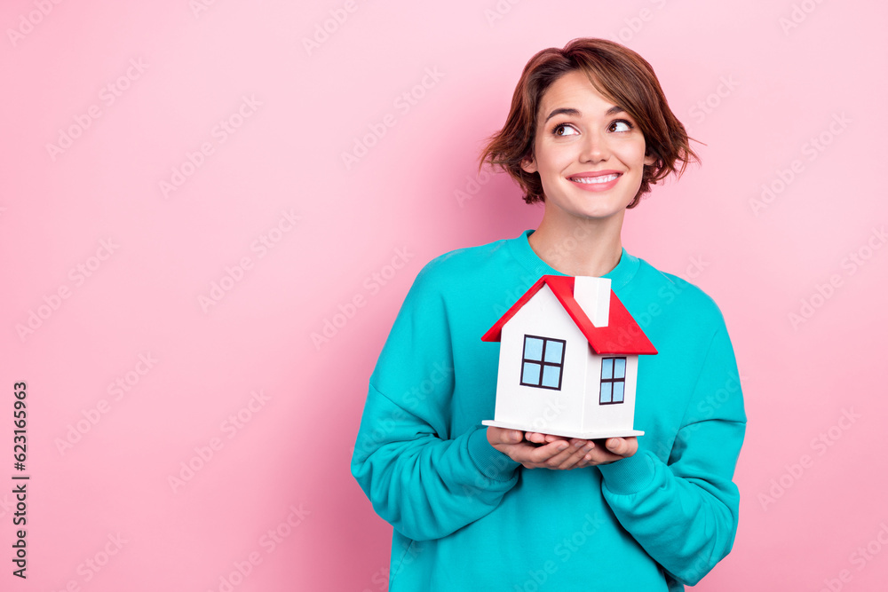 Portrait of positive lovely girl wear trendy teal jumper look up empty space dream buy new house isolated on pink color background Portrait of positive lovely girl wear trendy teal jumper look up empty space dream buy new house isolated on pink color background