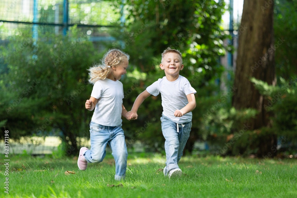 Little kids schoolchildren pupils running in park from school.