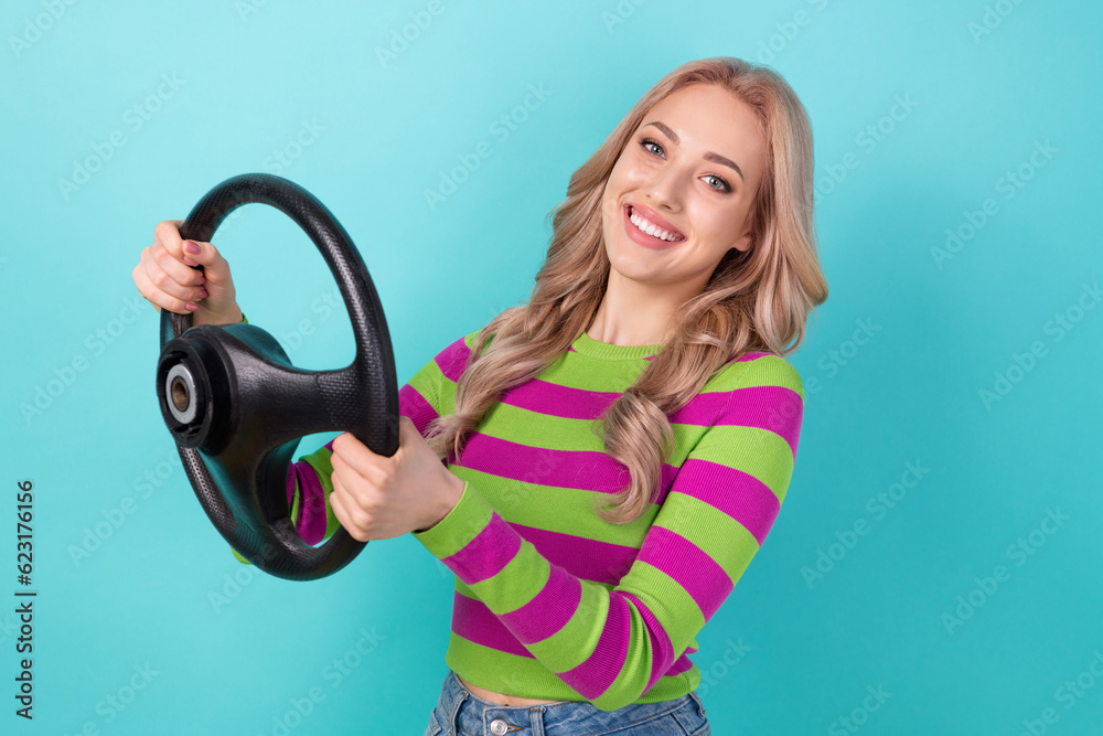 Photo of adorable woman curly hairstyle dressed striped sweatshirt hold steering wheel buy new vehicle isolated on teal color background Photo of adorable woman curly hairstyle dressed striped sweatshirt hold steering wheel buy new vehicle isolated on teal color background