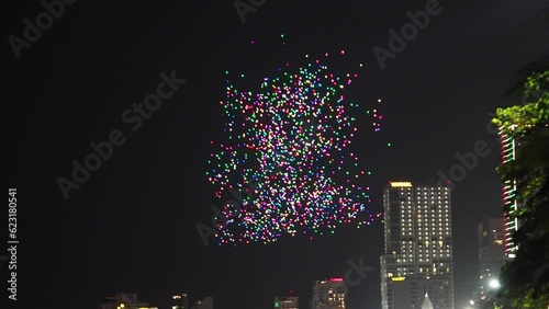 Video of flying drones glowing and going distant on the background of an urban city, Asian style, blur in the end, 4k