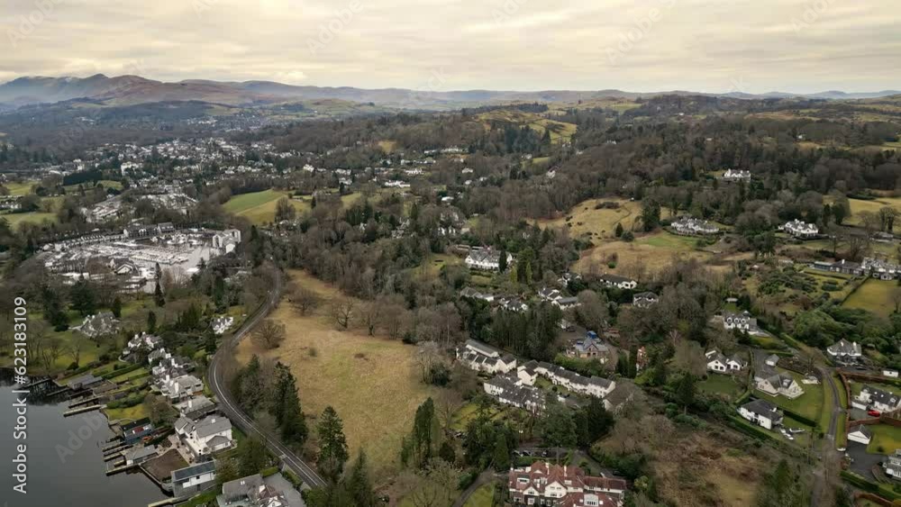 Dramatic beauty of the moody Cumbrian landscape through captivating drone footage, revealing Bowness-on-Windermere village embraced by majestic fells. Dramatic beauty of the moody Cumbrian landscape through captivating drone footage, revealing Bowness-on-Windermere village embraced by majestic fells.
