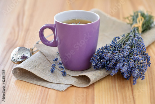Cup of tea and lavender flowers on a wooden table