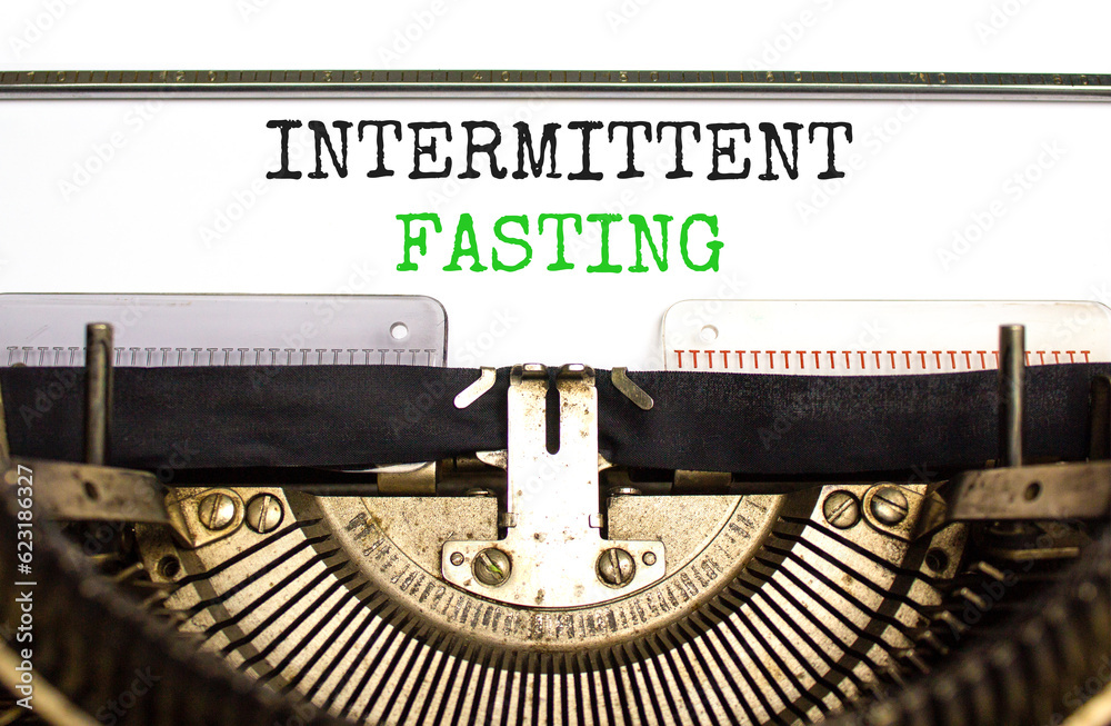 Intermittent fasting symbol. Concept words Intermittent fasting typed on beautiful old retro typewriter. Beautiful white background. Healthy lifestyle intermittent fasting concept. Copy space.