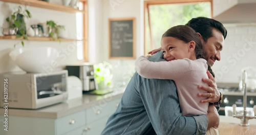 Family, father and daughter hug in the kitchen for love, trust or bonding together in their home. Kids, smile and safety with a happy young man embracing his adorable girl child in their house