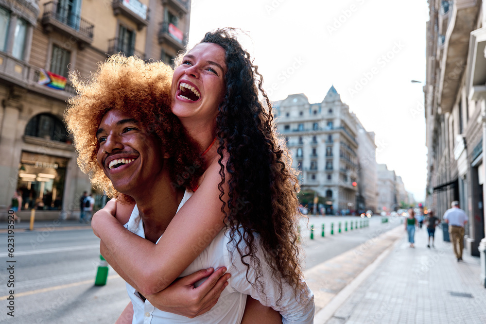 couple of tourists doing piggyback in Barcelona, Spain - obrazy, fototapety, plakaty 