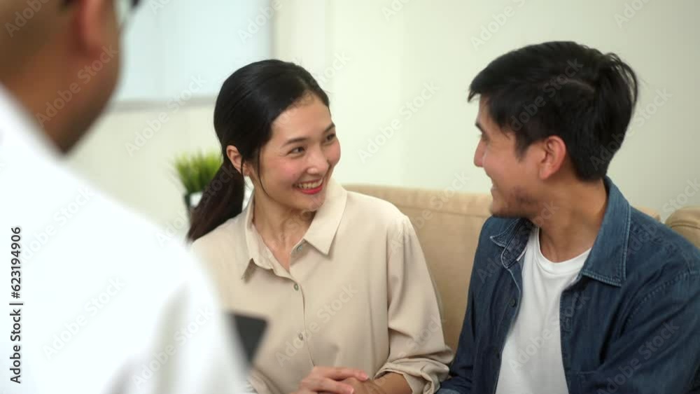 Happy moment patient spouses from doctor provides counseling, delivers good news pregnant, performs examinations for treatment of couples in clinic with tablet. Happy husband is supporting his wife.