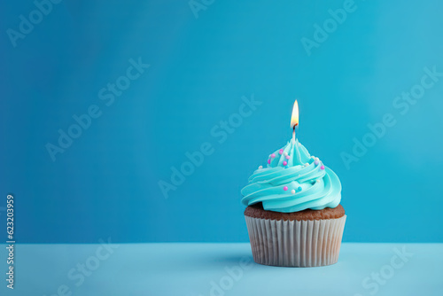 Blue Cupcake With Lighted Candle On Blue Background, Empty Space. Generative AI