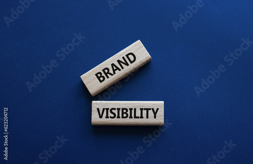 Brand visibility symbol. Wooden blocks with words Brand visibility. Beautiful deep blue background. Business and Brand visibility concept. Copy space.