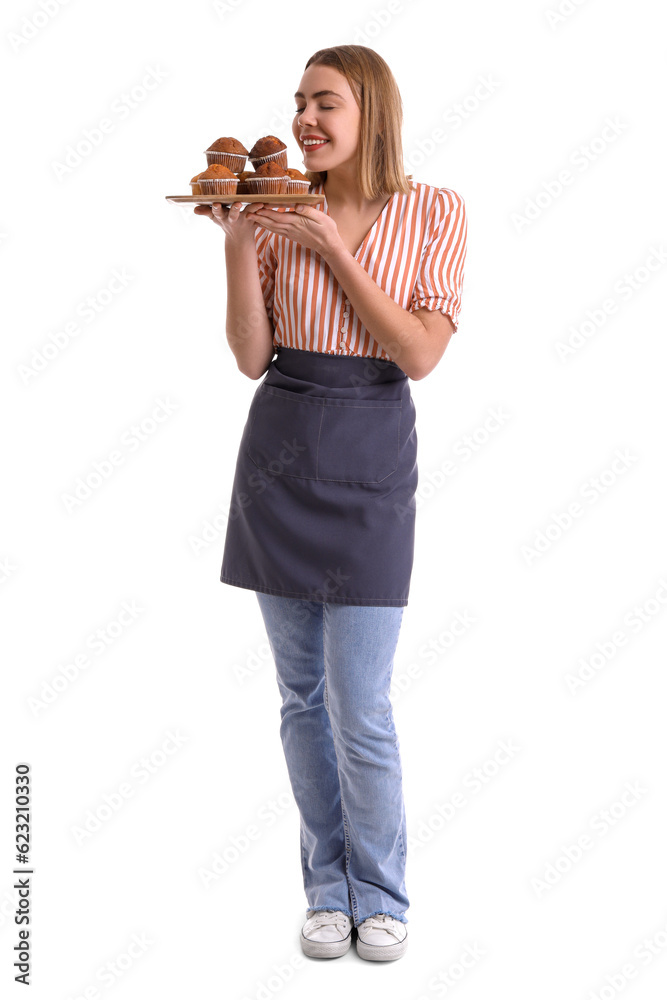 Female baker with tray of tasty cupcakes on white background Female baker with tray of tasty cupcakes on white background