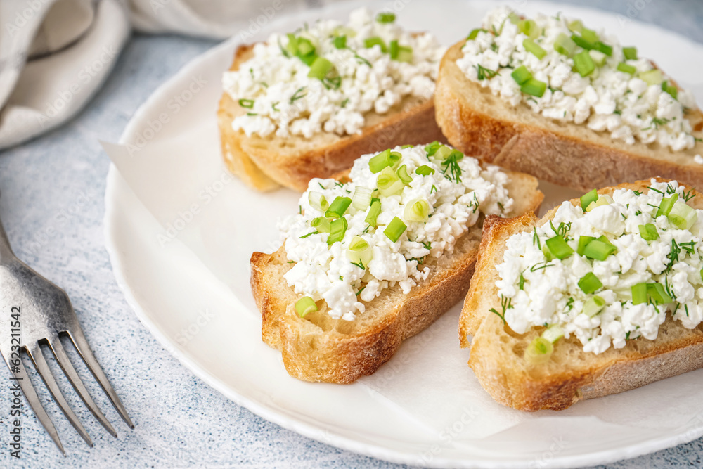 Sandwiches with tasty cottage cheese and green onion on grey background