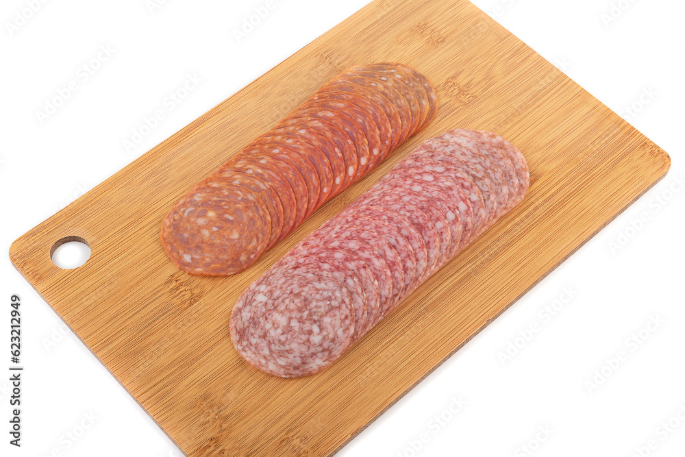 Sliced chorizo and cervelat sausages on a cutting board over white background. Sliced chorizo and cervelat sausages on a cutting board over white background.