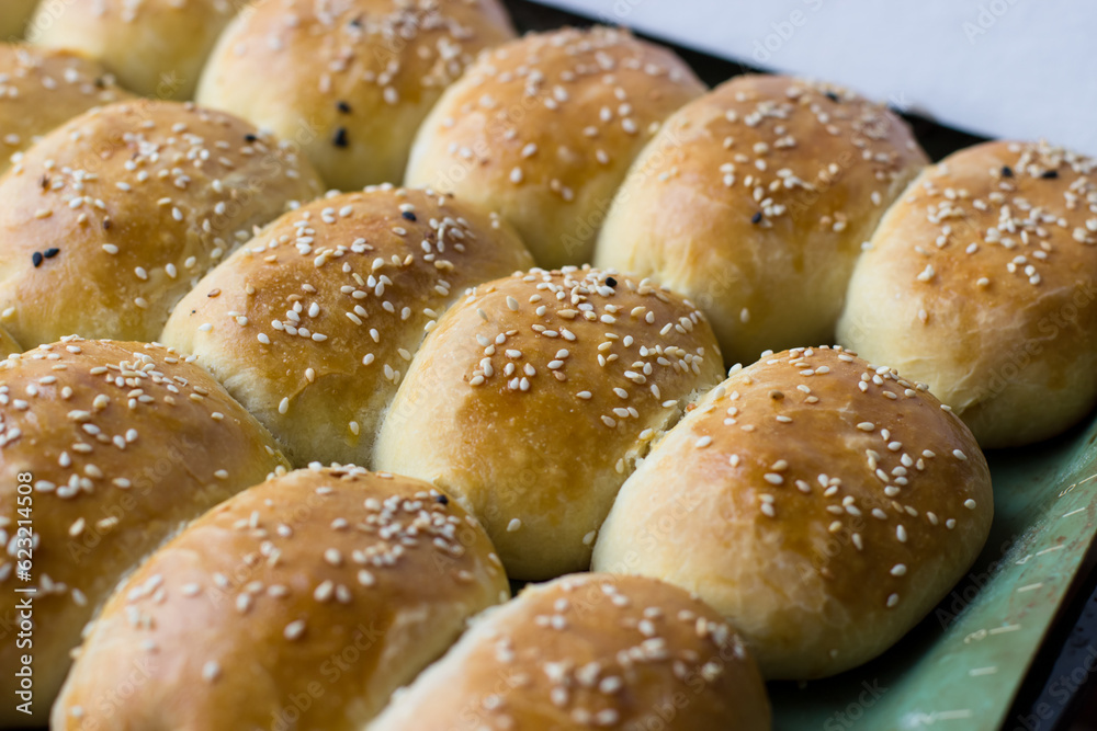 Homemade pies sprinkled with sesame seeds. Appetizing homemade cakes Homemade pies sprinkled with sesame seeds. Appetizing homemade cakes